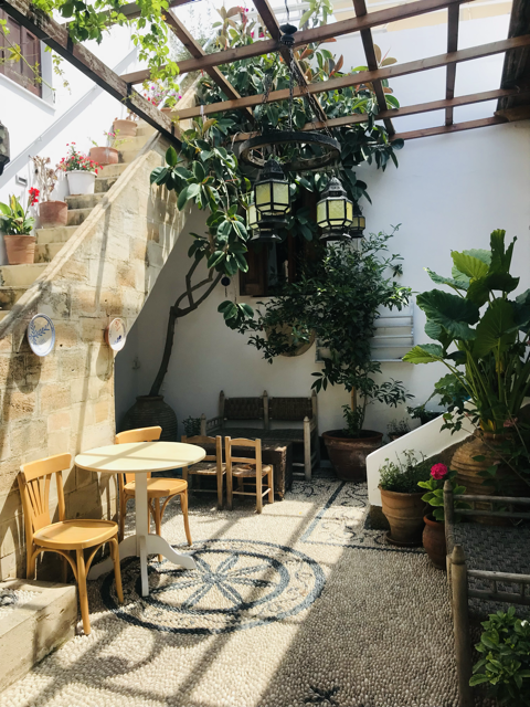 Greek Rooftop Taverna With chairs and plants